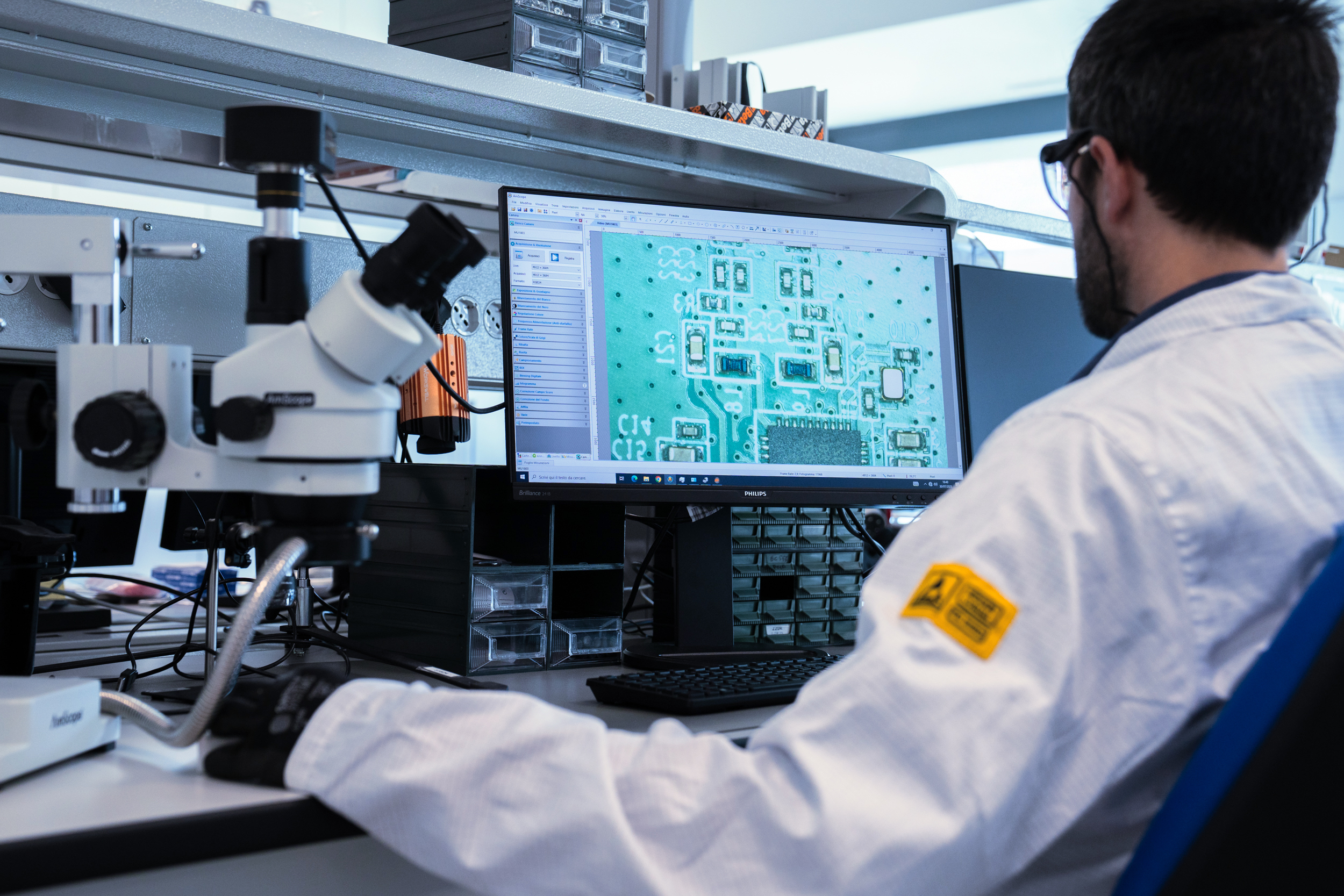 Bitron Electronics LAB. Salerno Additional Services Worker in front of a computer testing an electronic board